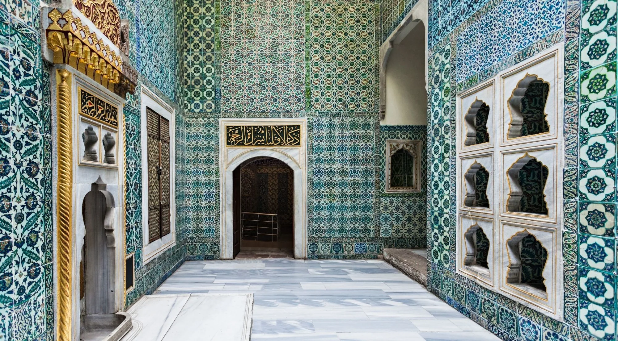 A small Harem courtyard at Topkapi Palace faced floor to ceiling in turquoise and blue Iznik tiles around a marble doorway