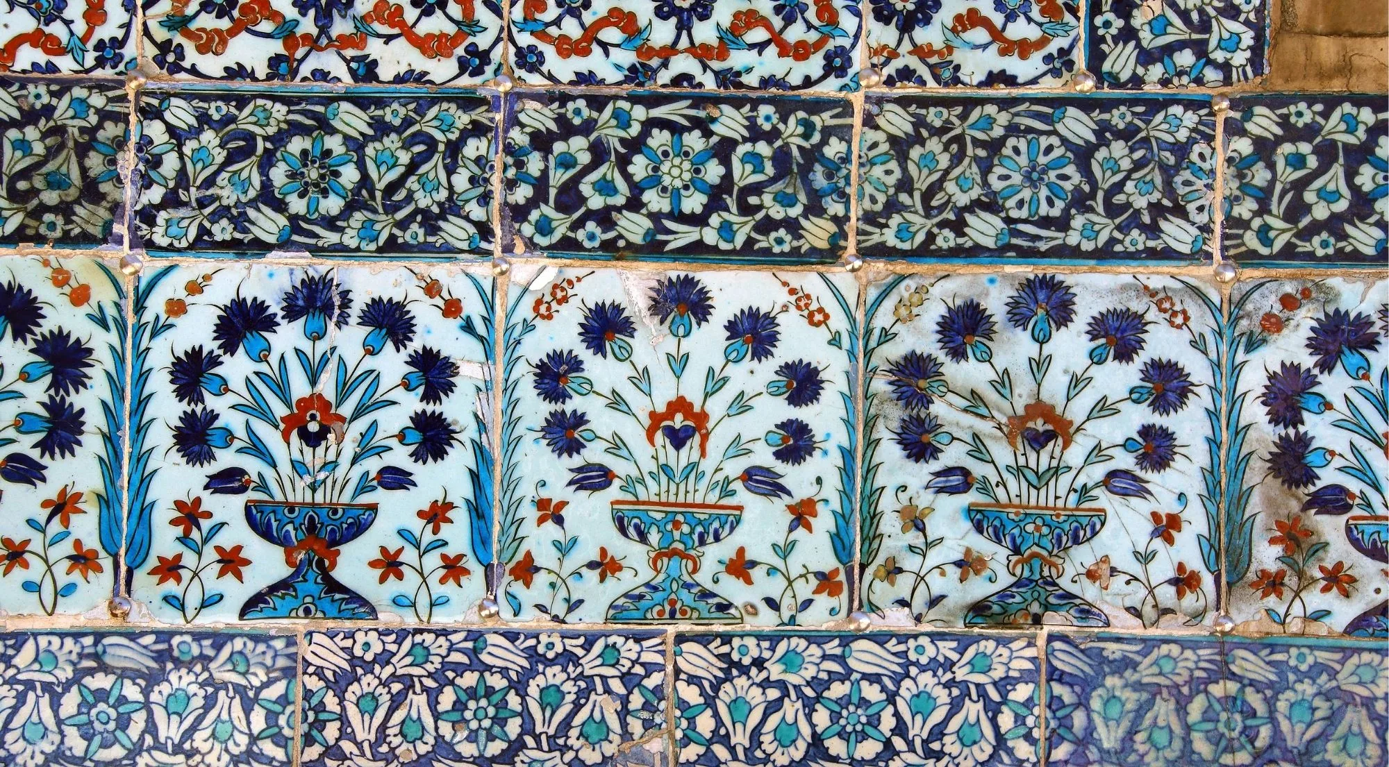 Close view of Iznik tiles at Topkapi Palace showing cobalt blue carnations and tulips with bole-red accents on a white ground