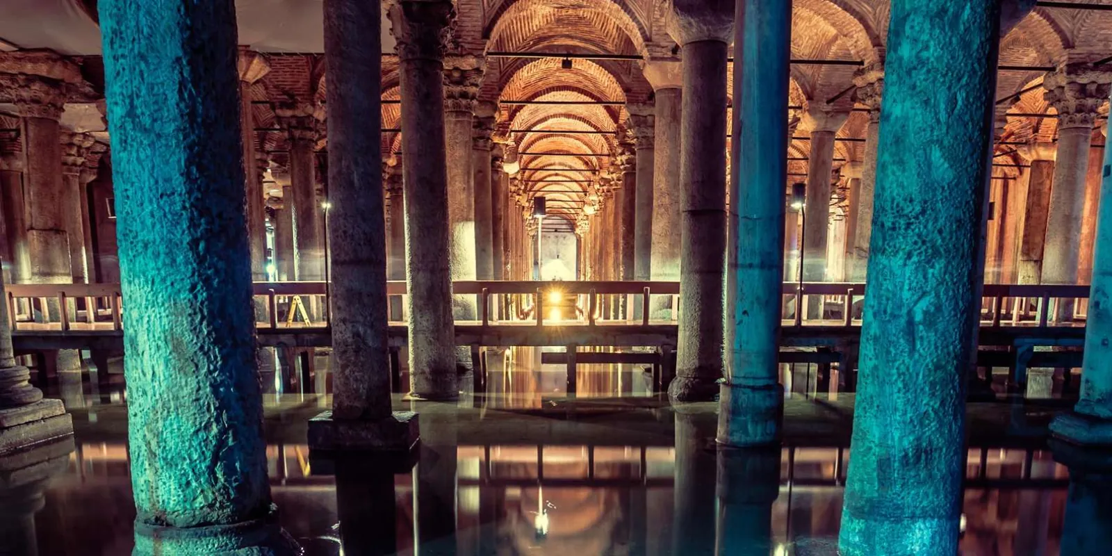 The illuminated columns of the Basilica Cistern reflected in the water of the underground reservoir